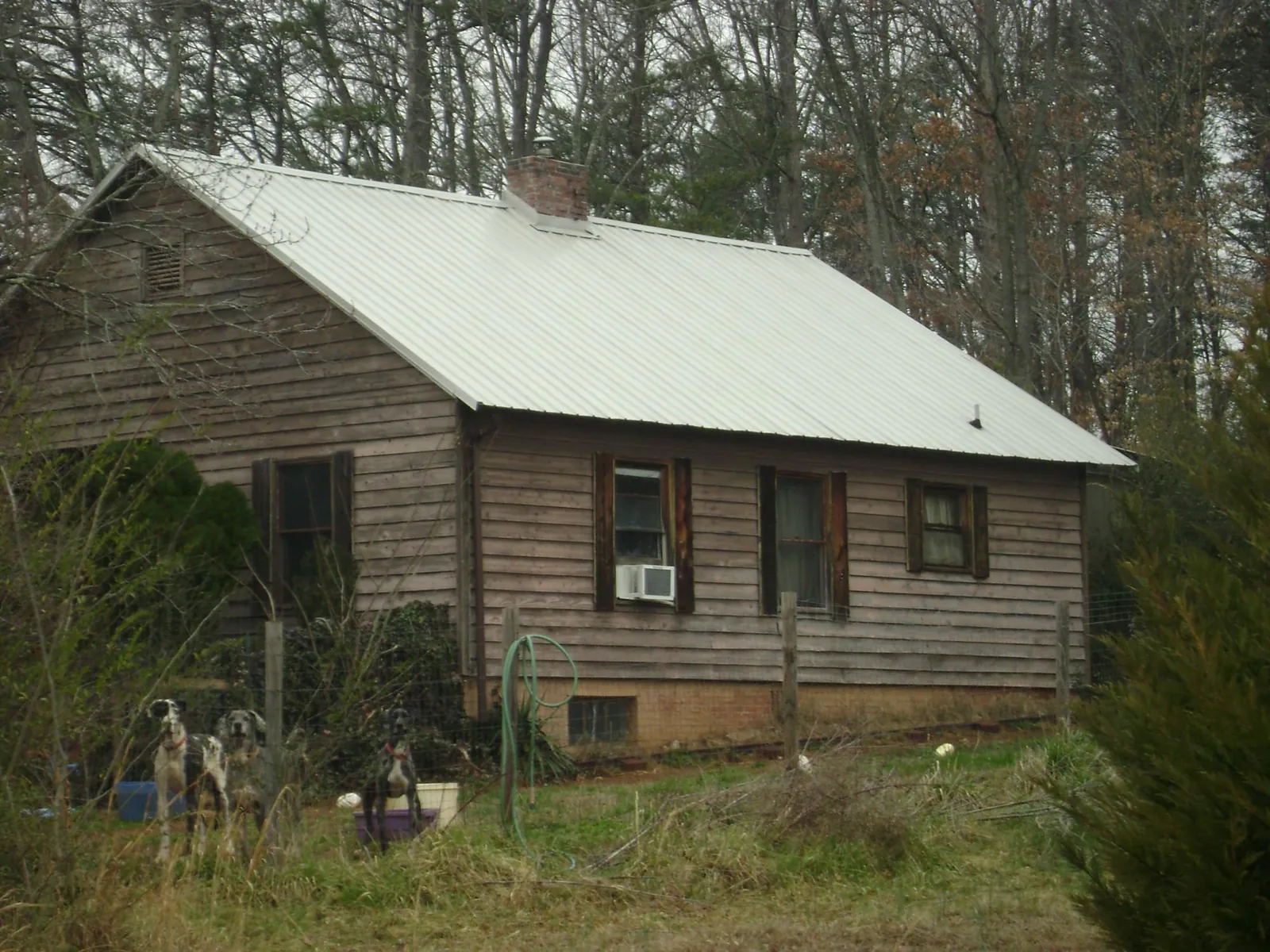 White metal roof on an old wood sided farmhouse, from a Metal Roof Installation job in Courtland